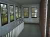 enclosed back porch (railing around stairway to basement)