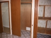 3 large storage closets in laundry room with door open